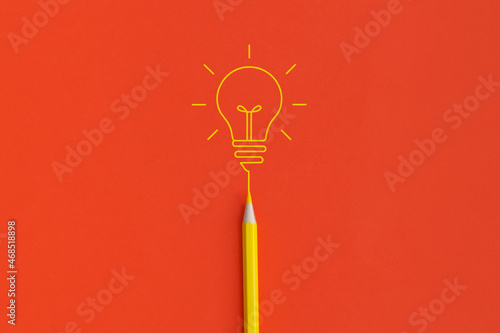 Light bulb on red background. Inspiration and creative idea concept. Top view with copy space. Flat lay composition. photo