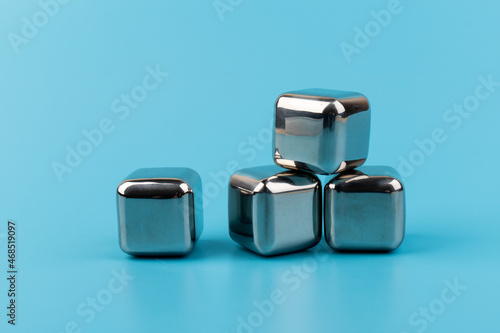 stainless steel ice cubes whiskey stones on blue background