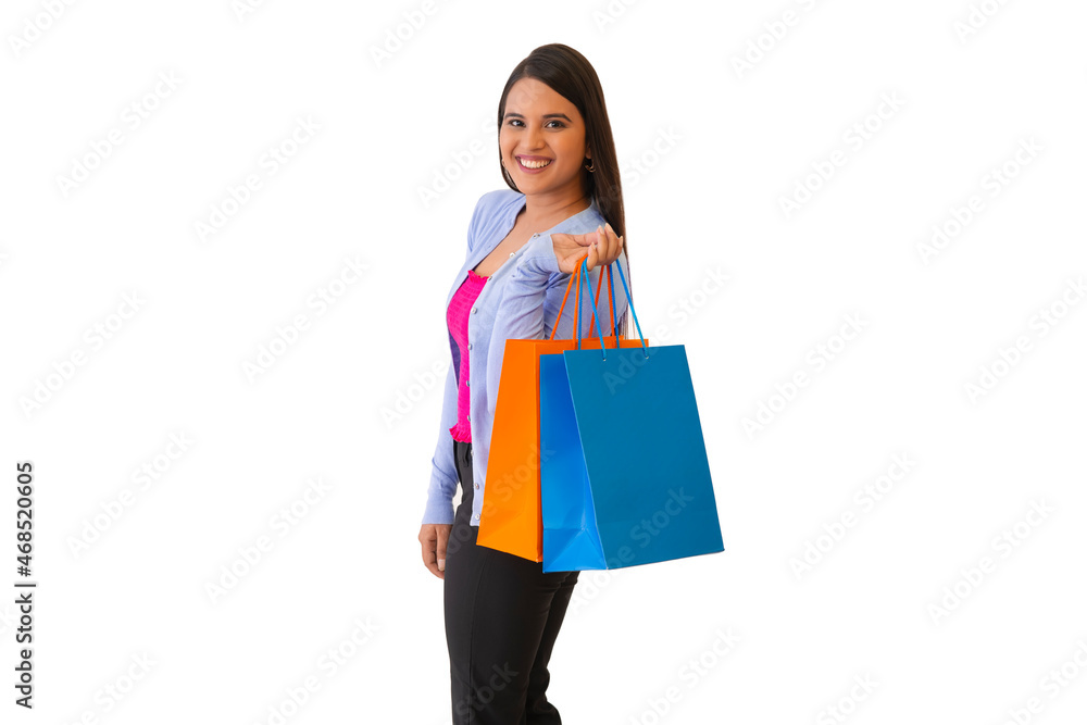 Indian lady posing in front of camera with shopping bags in her hand Indian lady posing in front of camera with shopping bags in her hand
