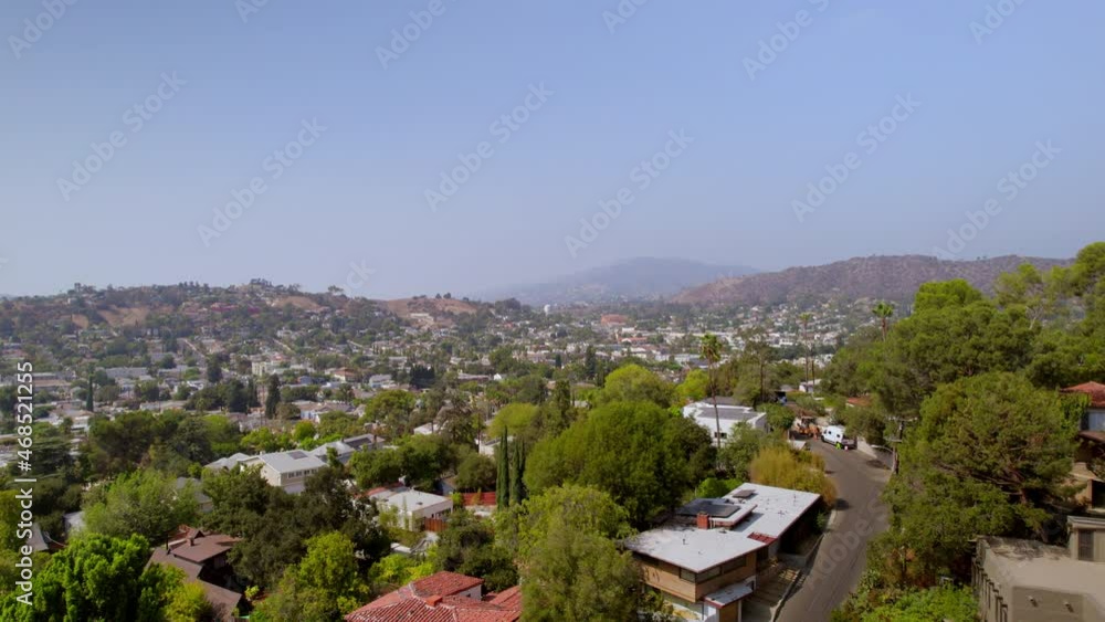 Low altitude flight over houses and street in Los Angeles neighborhood of Eagle Rock, California on a beautiful summer day. Low altitude flight over houses and street in Los Angeles neighborhood of Eagle Rock, California on a beautiful summer day.