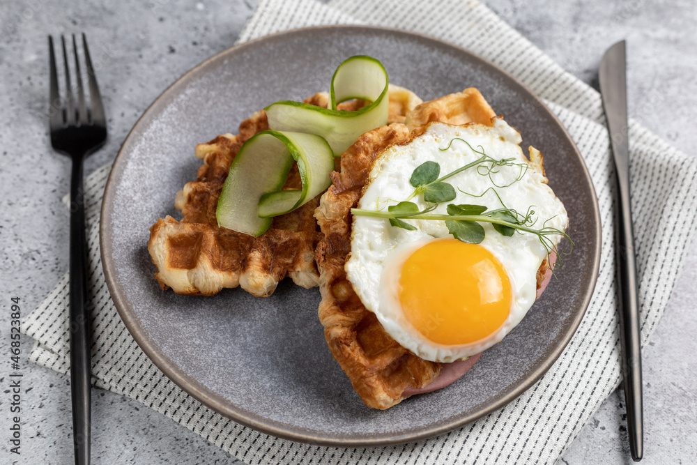 Breakfast with unsweetened croffles (Croissant waffle),
fried egg and vegetables. Breakfast with unsweetened croffles (Croissant waffle),
fried egg and vegetables.