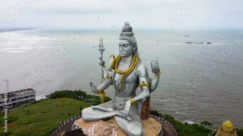 Mesmerizing aerial view of world's second highest Lord Shiva Statue surrounded by Arabian sea. This place is located in Murudeshwar, Karnataka (India). photo