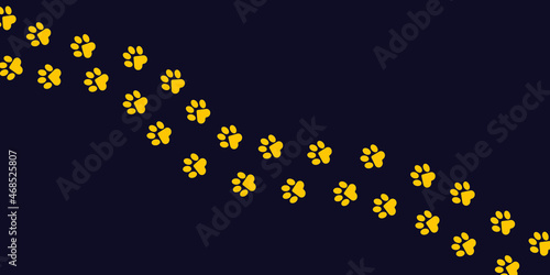 Paws of a cat, dog, puppy in yellow color on a dark purple background in a flat design. Diagonal animal footprints for veterinary clinic websites, postcards, posts about cute pets. Vector.