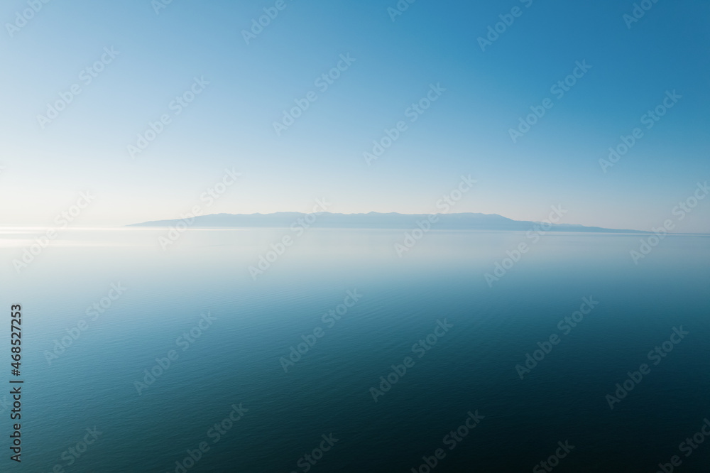 Summertime imagery of Lake Baikal is a rift lake located in southern Siberia, Russia Baikal lake summer landscape view from a cliff near Grandma's Bay. Drone's Eye View.