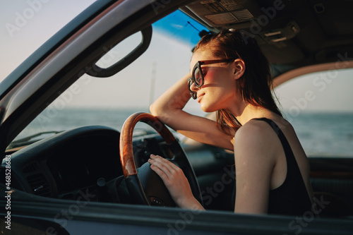 woman driving in car trip posing fashion travel