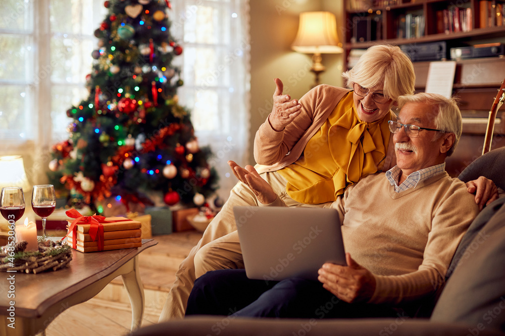 Happy senior couple has fun during video call on Christmas at home. Happy senior couple has fun during video call on Christmas at home.