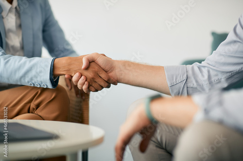 Close-up of business people handshaking on meeting in office. photo