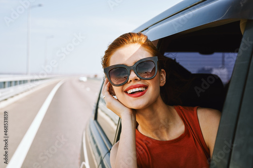 pretty woman in sunglasses rides in a travel car