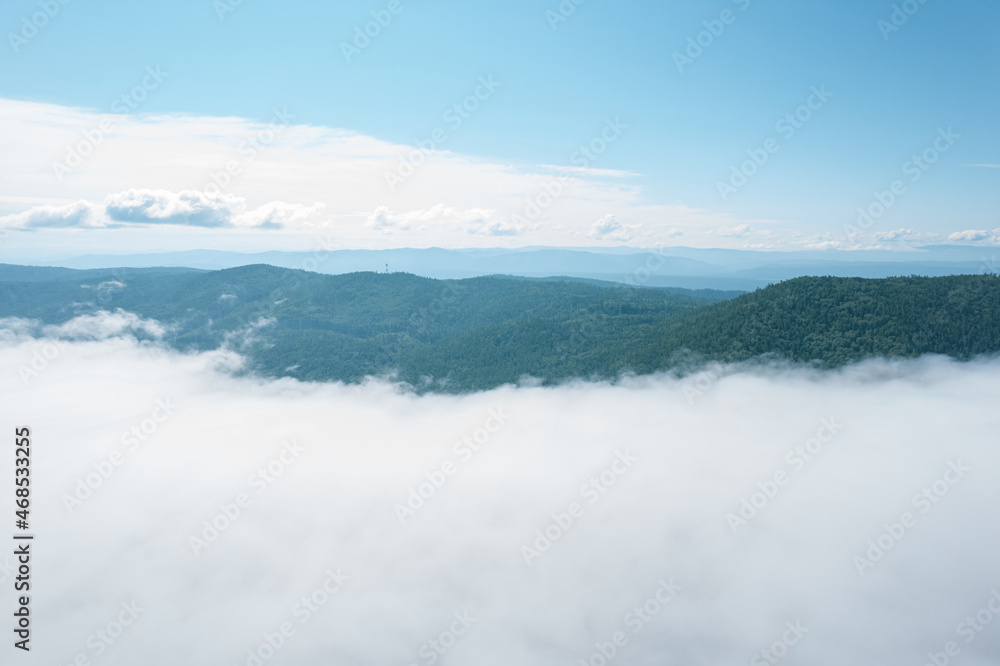 Flying through the clouds above mountain tops. High peaks wonderful morning sunrise natural Landscape