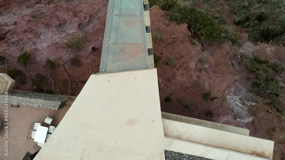 Top view of a modern architecture building with glass floor projecting out from the clifftop above Angulo, La Gomera, Canary Islands. Top view of a modern architecture building with glass floor projecting out from the clifftop above Angulo, La Gomera, Canary Islands.