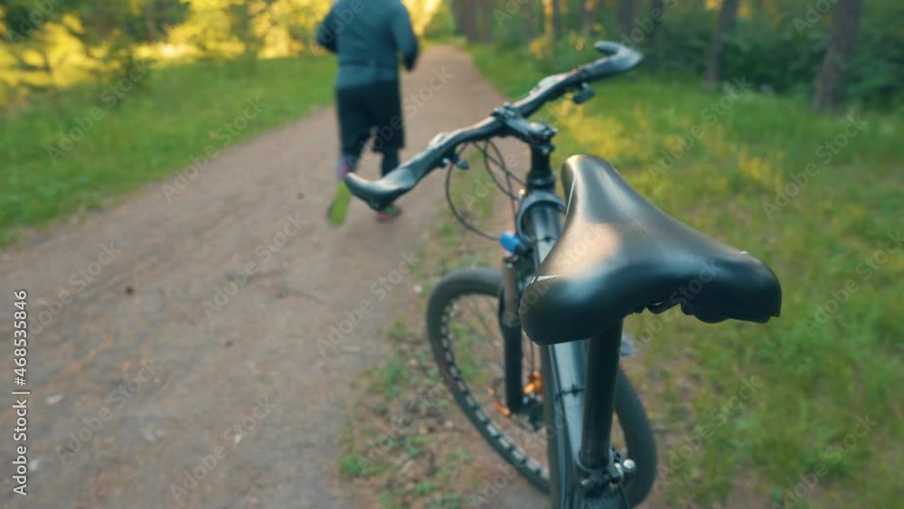 Sports Lifestyle Concept. Standing Bicycle and Nearby Running Runner. Who quickly. Cyclist Vs Runner. Different Kinds of Aerodynamic Load