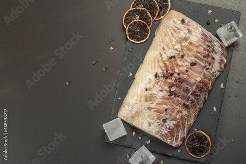 Raw pollock (Pollachius virens) fillet. Frozen fish for healthy food lifestyle photo