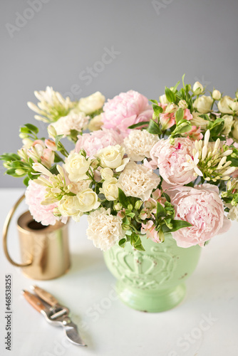 Beautiful flower arrangement in a green ceramic vase. Flowers bunch, set for interior. Fresh cut flowers for decoration home. European floral shop. Delivery fresh cut flower.v © malkovkosta