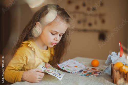 Cute little girl writes a letter to Santa Claus. Christmas concept