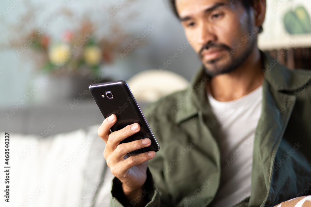 Lifestyle man using smartphone at home, connection, communication, application concept Lifestyle man using smartphone at home, connection, communication, application concept
