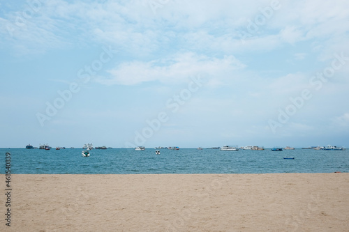 boats in Pattaya sea, beach, and urban city with blue sky for travel background. Chonburi, Thailand.
