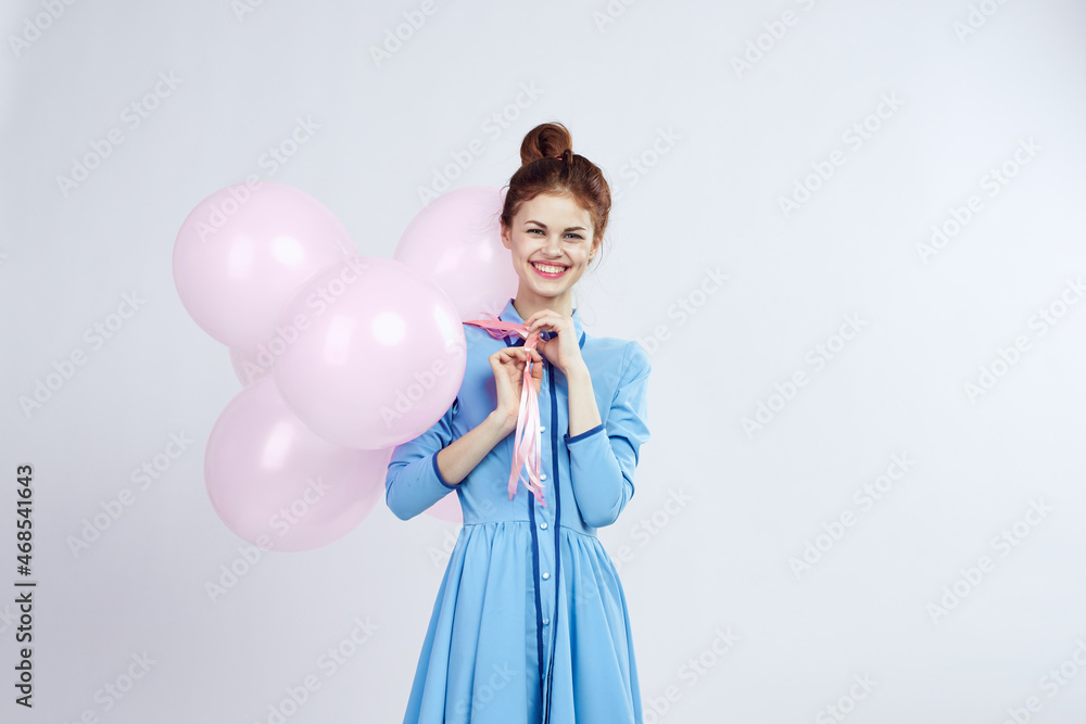 cheerful woman in a blue dress pink balloons holiday birthday