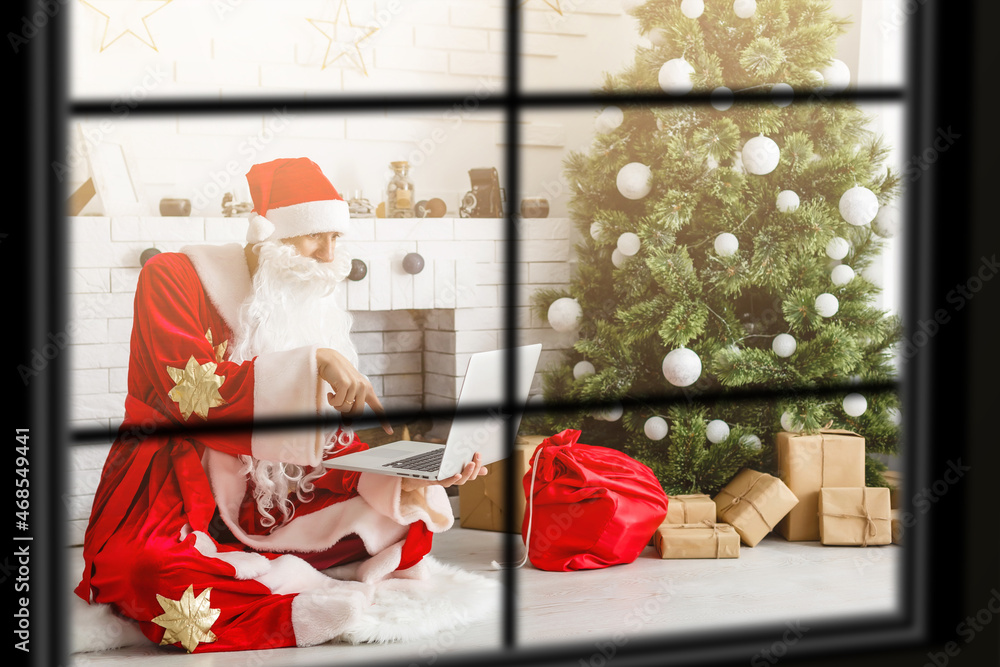 Fototapeta premium wiew through the window, Christmas Tree on background, winter holiday concept,