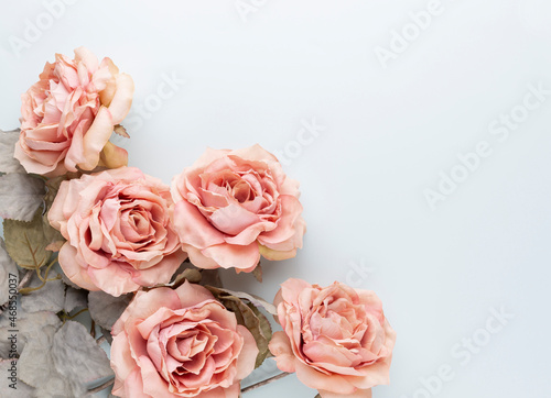 Flowers composition. Bouquet of pink roses in pastel colors. Flatlay.