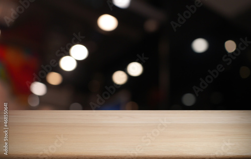 Empty wooden table in front of abstract blurred background of coffee shop . can be used for display or montage your products.Mock up for display of product