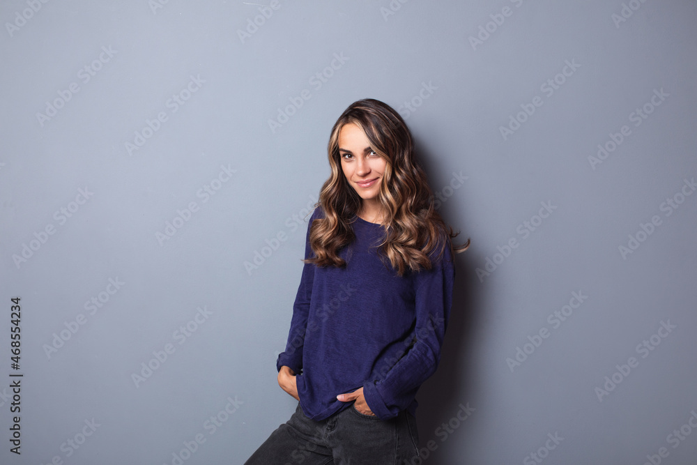 Portrait of a beautiful smiling modern woman on a gray background Portrait of a beautiful smiling modern woman on a gray background