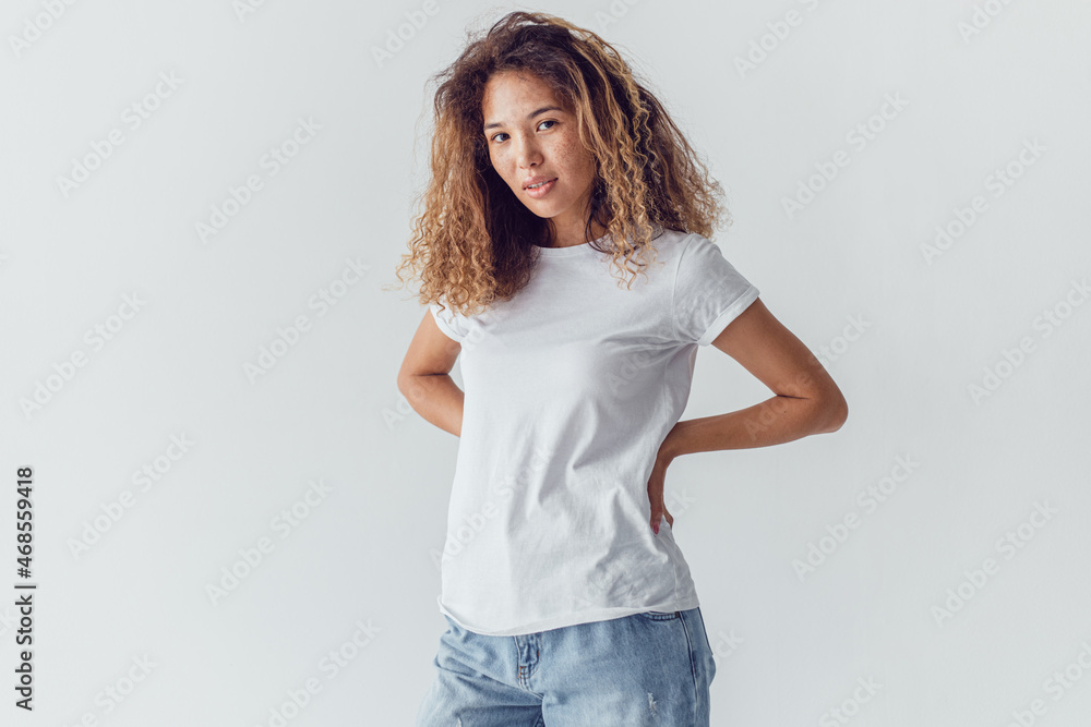 Attractive woman with lush curly hair wearing a white t-shirt. Mock-up. Attractive woman with lush curly hair wearing a white t-shirt. Mock-up.