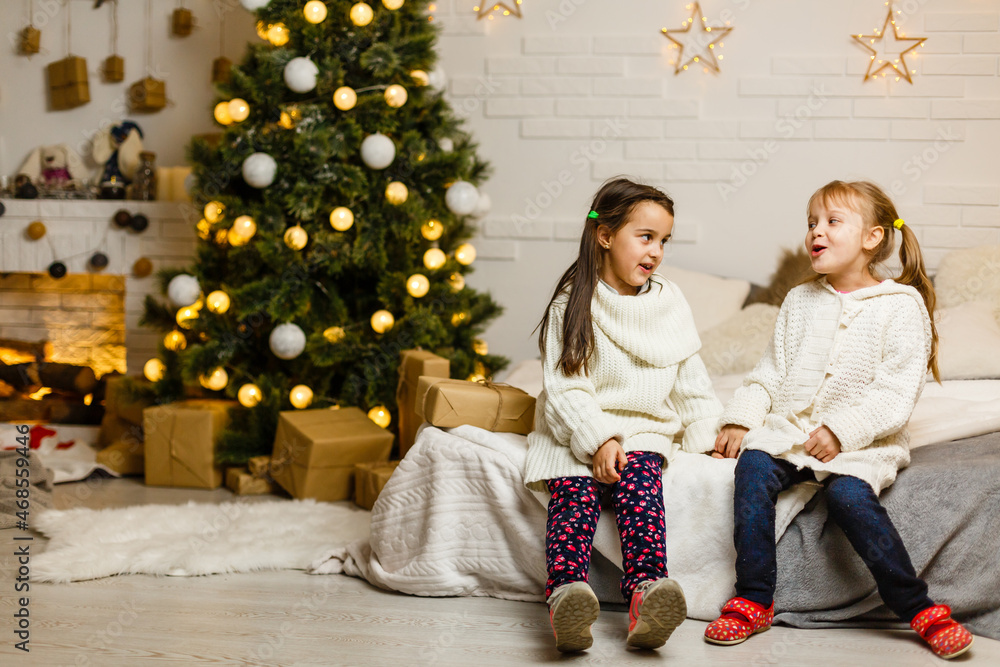 two little girls Sharing a Surprise on Christmas Morning two little girls Sharing a Surprise on Christmas Morning