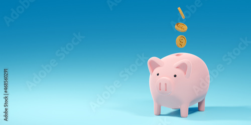 Coins falling into a pink piggy bank on blue background with copy space, 3d render