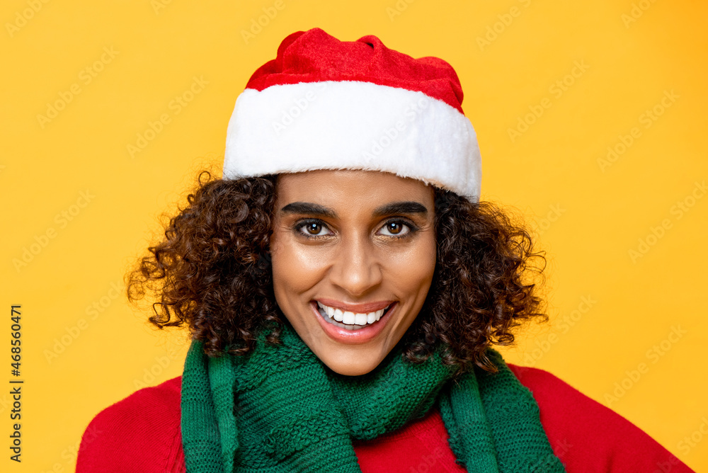 Close up portrait of pretty smiling woman in Christmas attire looking at camera on isolated colorful yellow background Close up portrait of pretty smiling woman in Christmas attire looking at camera on isolated colorful yellow background