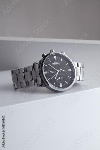 Luxury silver watch on white Table. Business man accessories.