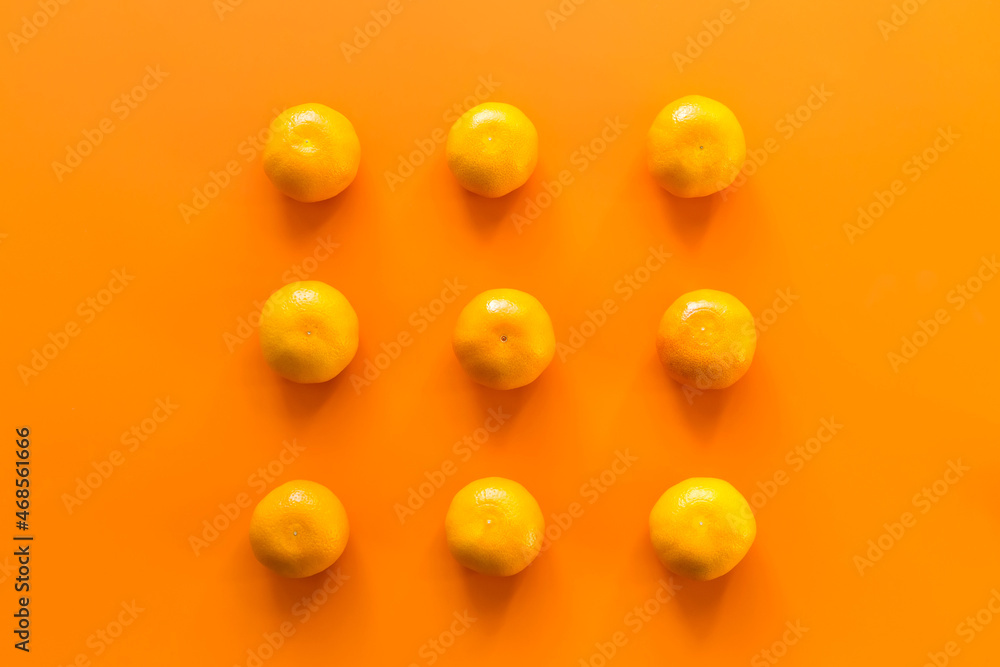 Mandarin, tangerine citrus fruit on orange background. Top view.