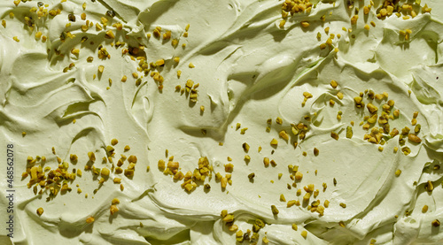 Creamy pistachio ice-cream with chopped fresh nuts photo