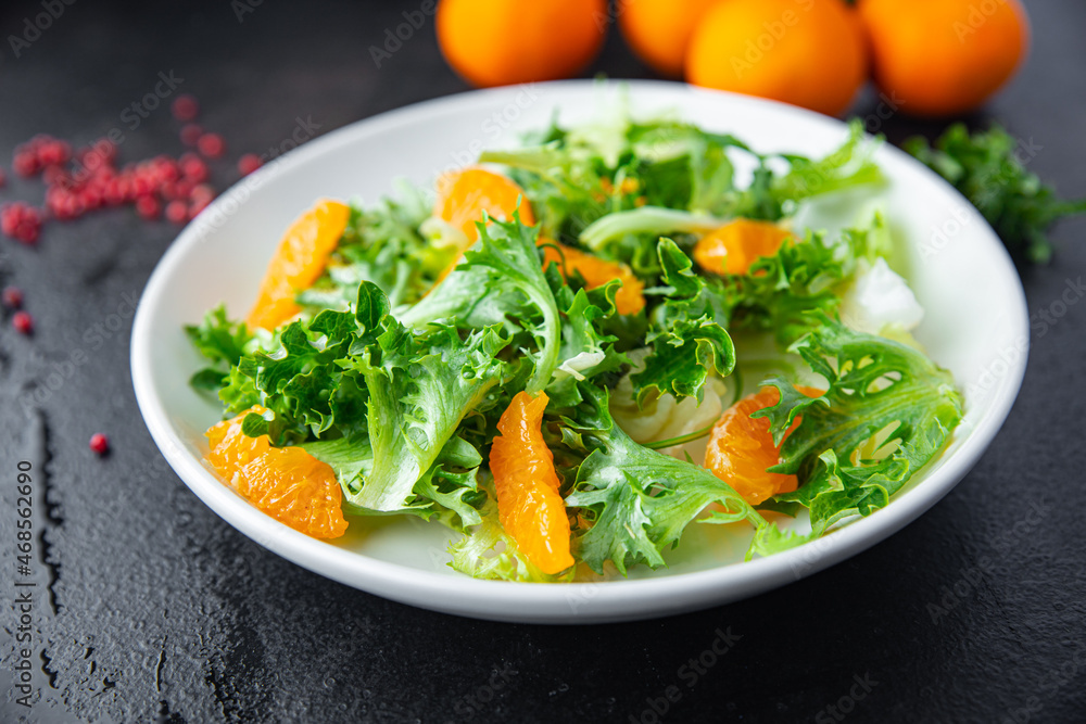 salad citrus lettuce, mix leaves, tangerine or orange meal snack on the table copy space food background rustic. top view keto or paleo diet veggie vegan or vegetarian food salad citrus lettuce, mix leaves, tangerine or orange meal snack on the table copy space food background rustic. top view keto or paleo diet veggie vegan or vegetarian food