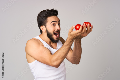 bearded man tomatoes in hand fresh vegetables health studio lifestyle