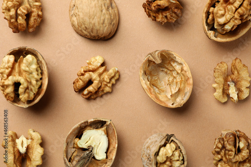 Flat lay composition with walnuts on brown background