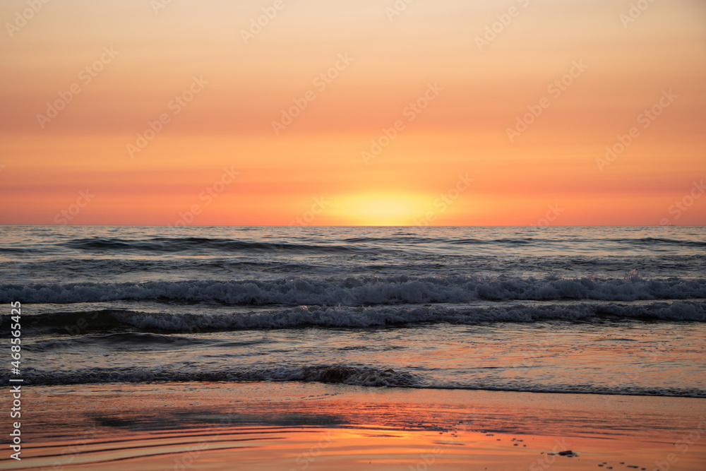Obraz premium Beautiful orange Sunset at the Beach in El Palmar Andalucia Spain at the Costa de la Luz