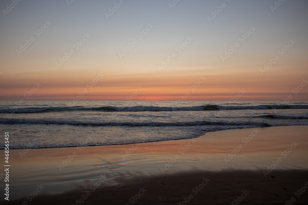 Fototapeta premium Beautiful orange Sunset at the Beach in El Palmar Andalucia Spain at the Costa de la Luz