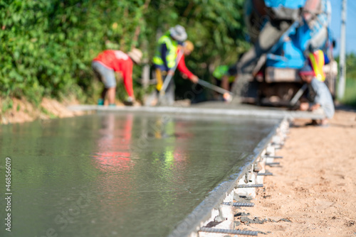 Pouring concrete slab at road construction site, Civil Engineer
