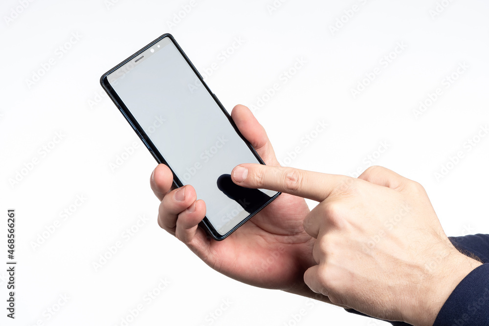 Hands show phone. Man points his finger at smartphone. Disabled cellphone for applications. Place to advertise applications. Space for mobile applications. Modern phone template. Hands show phone. Man points his finger at smartphone. Disabled cellphone for applications. Place to advertise applications. Space for mobile applications. Modern phone template.
