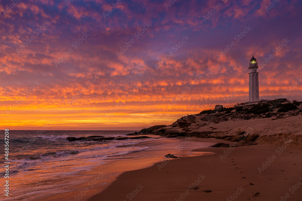Atardecer de nubes rojas en la playa del faro de Trafalgar, Caños de Meca, provincia de Cádiz, Andalucía, España Atardecer de nubes rojas en la playa del faro de Trafalgar, Caños de Meca, provincia de Cádiz, Andalucía, España