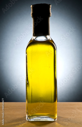 Olive oil bottle isolate on black and grey background