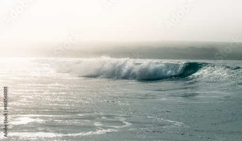 Soft haze and light over a glazed wave, Orkney