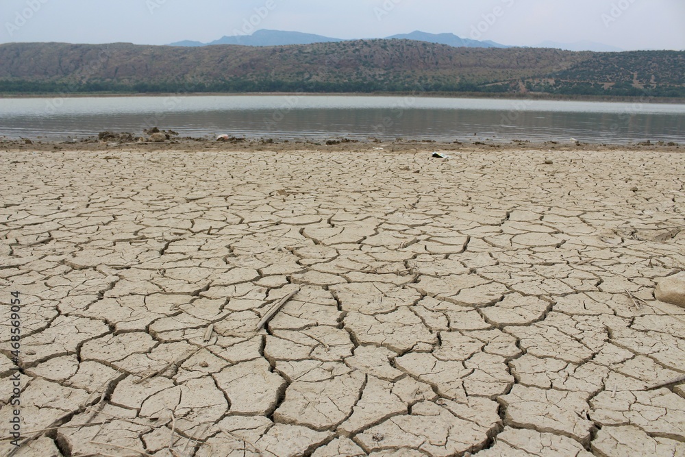 Dry and cracked land, dry due to lack of rain. Effects of climate change such as desertification and droughts.
