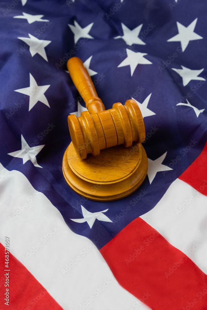 Judge wooden gavel on usa, united states of america flag background.