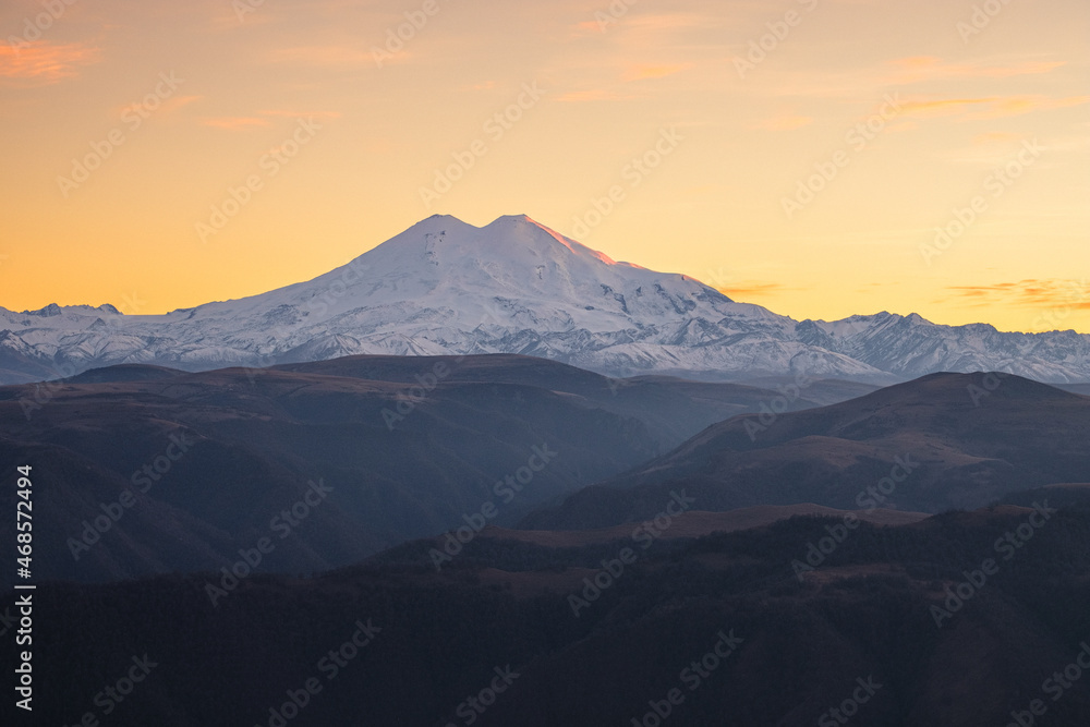 Autumn mountain landscape in the haze. Mount Elbrus in the background