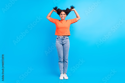 Full length photo of young cheerful afro woman happy positive smile have fun tails isolated over blue color background