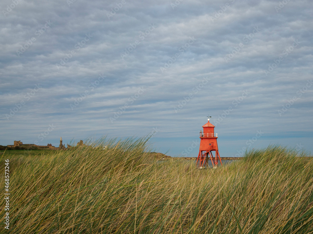 The Groyne Lighthouse,  South Shields, marram grass on dunes, open blue sky, North East England 