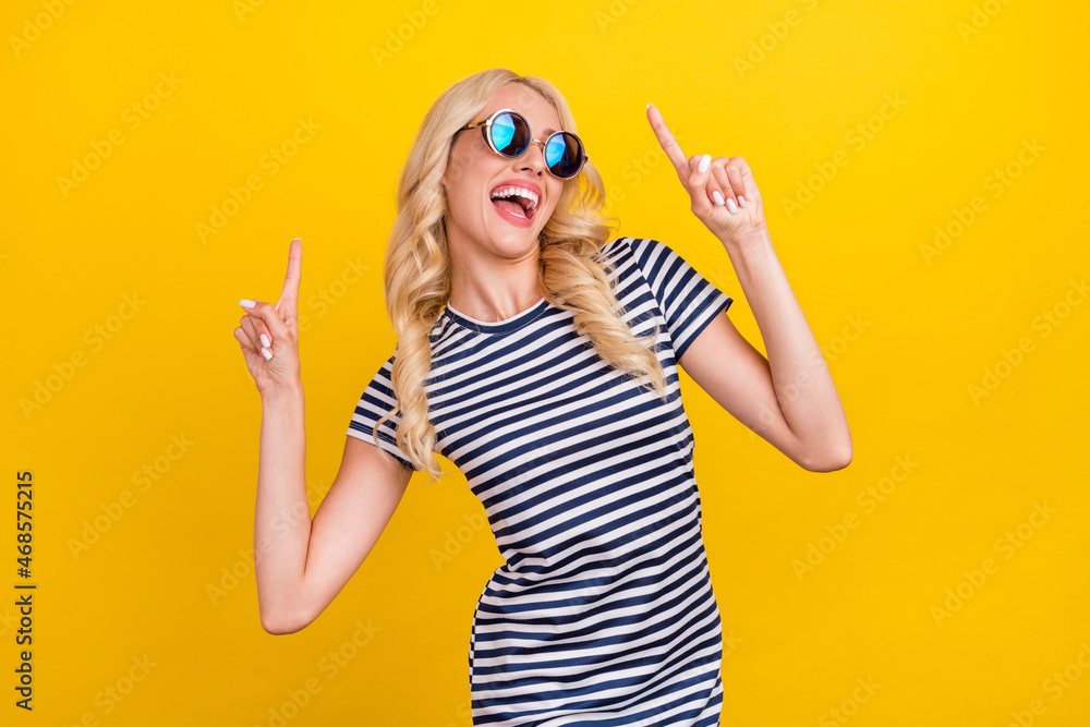 Portrait of attractive cheerful girl dancing having fun resting clubbing isolated over vibrant yellow color background Portrait of attractive cheerful girl dancing having fun resting clubbing isolated over vibrant yellow color background