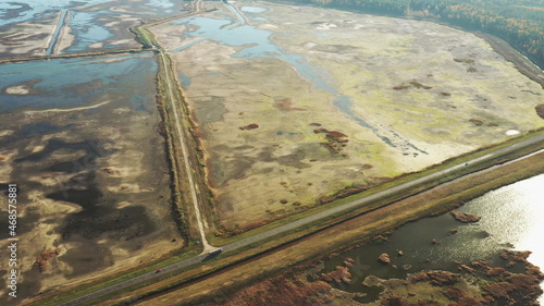 Aerial View Of Highway Road Through Ponds Autumn Landscape. Truck Tractor Unit Prime Mover Traction Unit In Motion On Freeway. Business Transportation. Top View  Drone View  Bird s Eye View