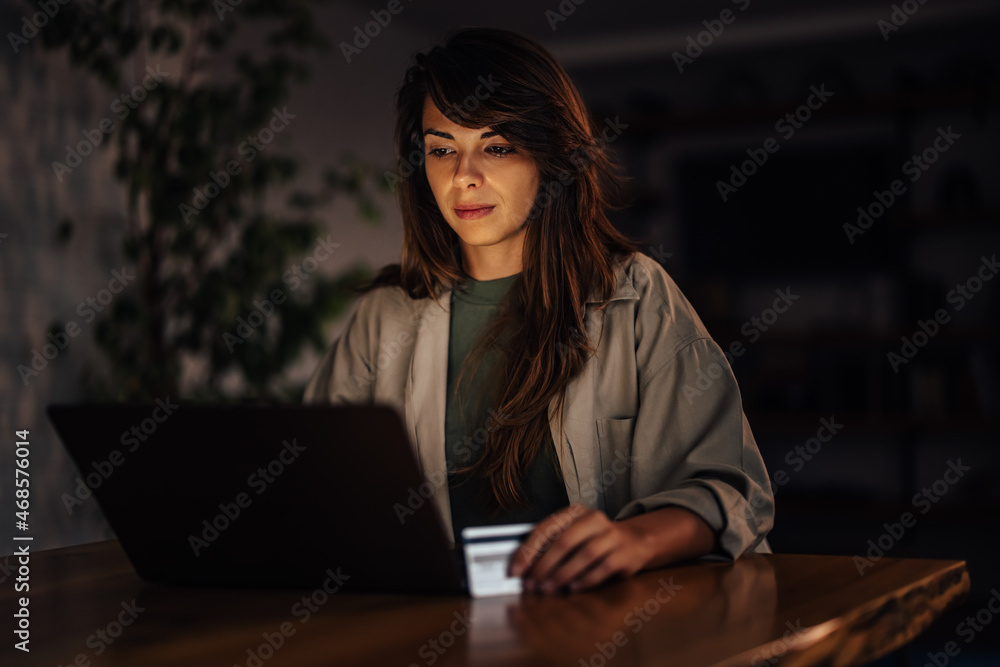 Focused adult woman, looking at her money balance Focused adult woman, looking at her money balance
